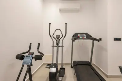 a room with two treadmill machines and a wall at Sky Sea View Villas in Chania Town