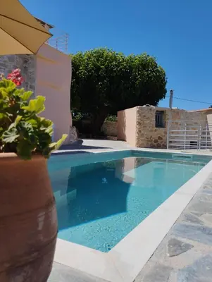 a swimming pool with blue water in a villa at Le Havre in Païdhokhórion