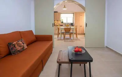a living room with a couch and a table at loupagio di mare in Plátanos