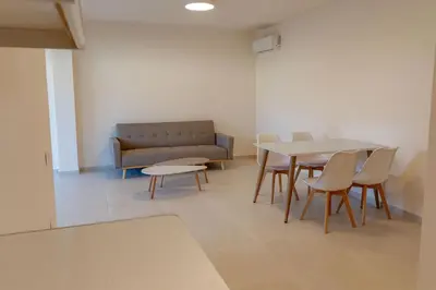 a living room with a couch and a table and chairs at Phaedrus Living Seaside Thalassa Cretan 101 in Módhion