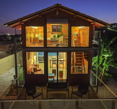 a small house with a large window and chairs at Casa Luma near Loutraki beach in Chania