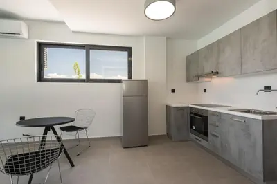 a kitchen with a table and some chairs and a table at Villa Aurora 1- Getaway Bliss in Xamoudhokhórion