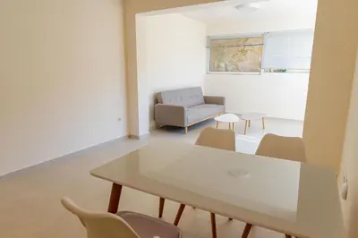 a living room with a table and chairs at Phaedrus Living Seaside Thalassa Cretan 102 in Módhion
