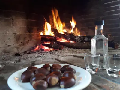 a plate ofocolates on a table in front of a fireplace at Panorama Apartment in Kefálion