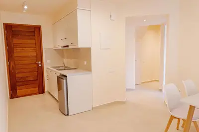 a kitchen with white appliances and a table and chairs at Phaedrus Living Seaside Thalassa Cretan 103 in Módhion
