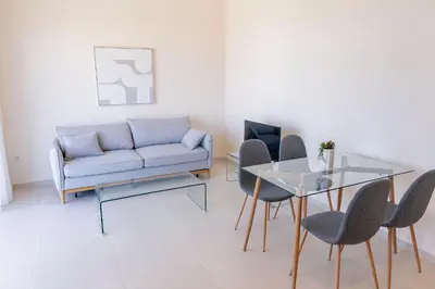 a living room with a couch and a glass table at Phaedrus Living Seaside Thalassa Cretan 201 in Módhion