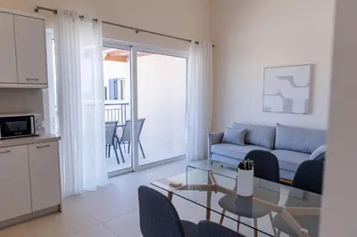 a living room with a couch and a glass table at Phaedrus Living Seaside Thalassa Cretan 201 in Módhion