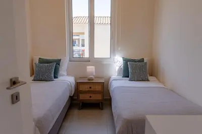 two twin beds in a room with a window at Phaedrus Living Seaside Thalassa Cretan 201 in Módhion