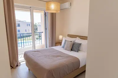 a bedroom with a bed and a large window at Phaedrus Living Seaside Thalassa Cretan 202 in Módhion