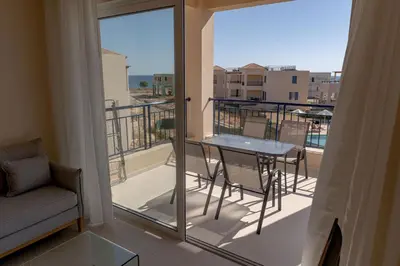 a balcony with a table and chairs on a balcony at Phaedrus Living Seaside Thalassa Cretan 203 in Módhion