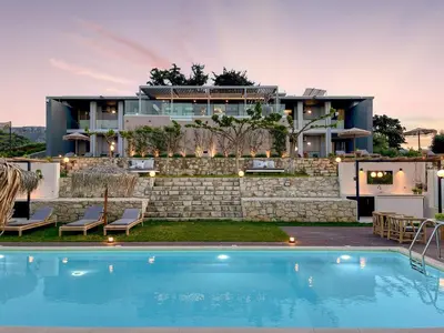 a house with a swimming pool in front of a house at Luxury Villa Olivenest with Private Heated Pool, Hot Tub & Sauna in Chania Town