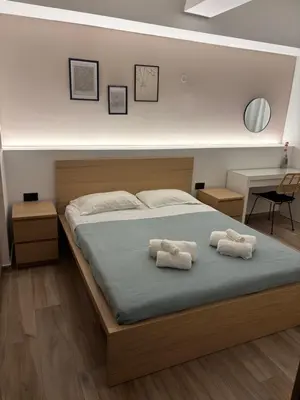 a bedroom with a bed with two towels on it at Sofia's Home in Chania Town