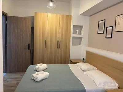 a bedroom with two folded towels on a bed at Sofia's Home in Chania Town