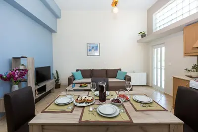 a kitchen and living room with a table with food on it at Arnildi's View in Nopíyia