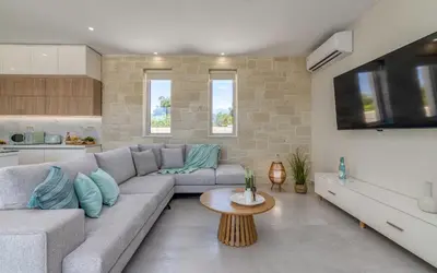 a living room with a couch and a table at Villa Navelina in Mourí