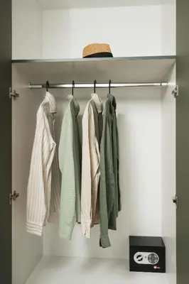 a closet with a rack of clothes at Thamon lifestyle living in Chania Town