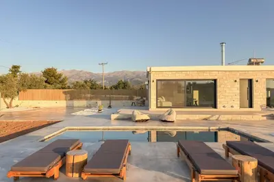 a house with a swimming pool with two loungers at Villa Kumarēs in Alikianós
