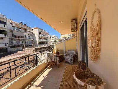 a balcony with chairs and a table on a building at Onar-estia in Chania Town