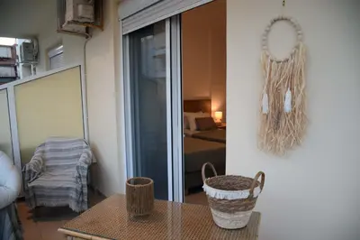 a living room with a table and a bedroom at Onar-estia in Chania Town