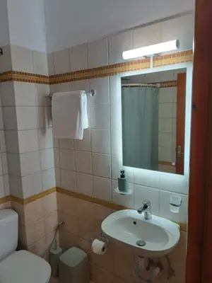 a bathroom with a sink and a toilet and a mirror at Onar-estia in Chania Town