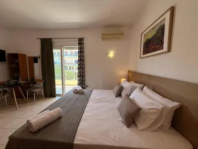 a bedroom with a large bed and a dining room at Onar-estia in Chania Town
