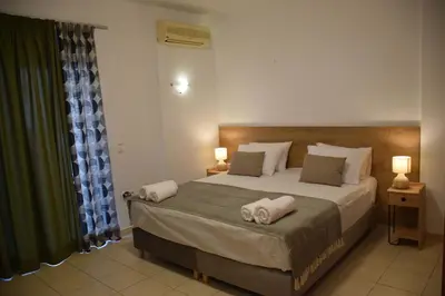 a bedroom with a large bed with towels on it at Onar-estia in Chania Town