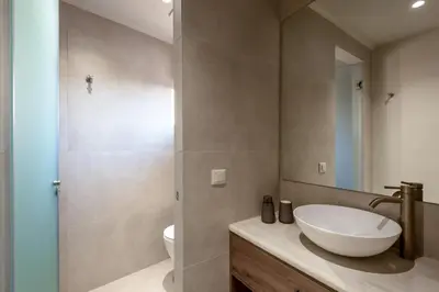 a bathroom with a sink and a toilet at Olive Hideaway Private Pool Villa, Chania Sleeps 7 in Kalamitsi Amygdali