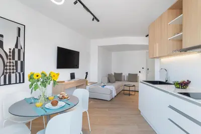 a kitchen and living room with a table and chairs at Neapolis in Chania Town