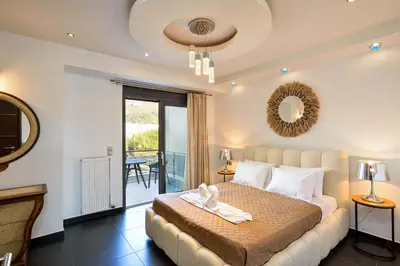 a bedroom with a bed and a balcony at Arieldine Luxury Apartment in Chania Town