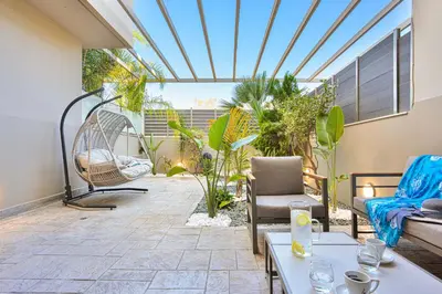 an outdoor patio with furniture and a glass ceiling at Arieldine Luxury Apartment in Chania Town
