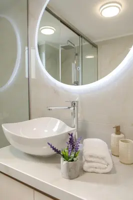 a bathroom with a sink and a mirror at Yume Luxury Home in Pírgos