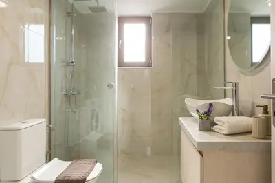 a bathroom with a shower and a toilet and a sink at Yume Luxury Home in Pírgos