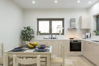 a kitchen with a table with a bowl of fruit on it at Yume Luxury Home in Pírgos