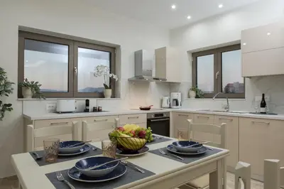 a kitchen with a table with a bowl of fruit on it at Yume Luxury Home in Pírgos