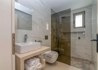 a bathroom with a sink and a toilet and a shower at Elafonisi Pearl in Elafonisi