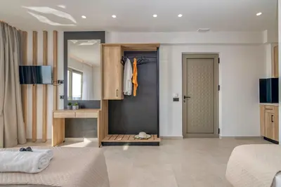 a bedroom with a closet and a bed and a door at Elafonisi Pearl in Elafonisi