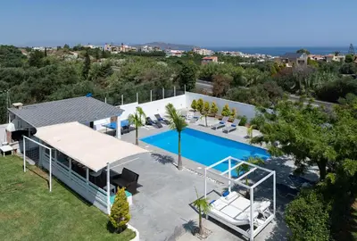 an aerial view of a house with a swimming pool at Myrto Villa heated pool in Kato Daratso