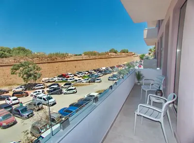 a balcony with cars parked in a parking lot at Melina Apartments Sea & City in Chania Town