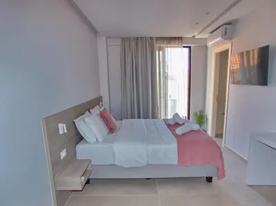a bedroom with a bed and a large window at Melina Apartments Sea & City in Chania Town