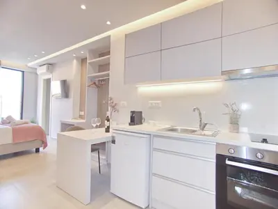 a white kitchen with a sink and a stove at Melina Apartments Sea & City in Chania Town