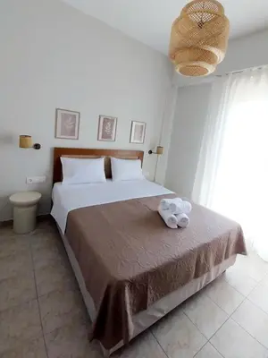 a bedroom with a bed with a towel on it at Lithos in Palaiochóra
