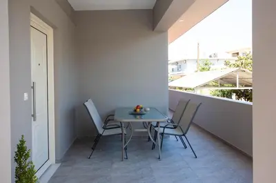 a table and chairs sitting on a balcony at Maira City House in Chania Town