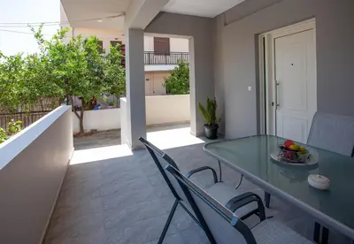 a dining room with a green table and chairs at Maira City House in Chania Town