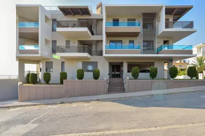 an apartment building with balconies and a parking lot at Marena Apartments in Chania Town