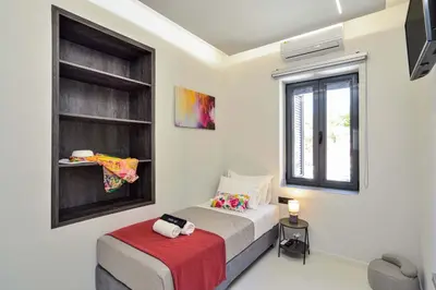 a bedroom with a bed and a window at Artemis Luxury Home in Chania Town