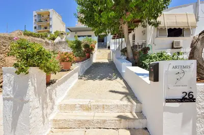 a white house with stairs and potted plants at Artemis Luxury Home in Chania Town