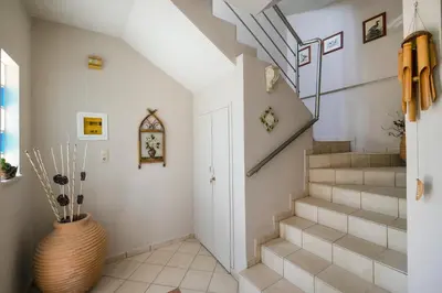 a staircase in a home with a vase at Nektar Luxury Apartment in Stalos
