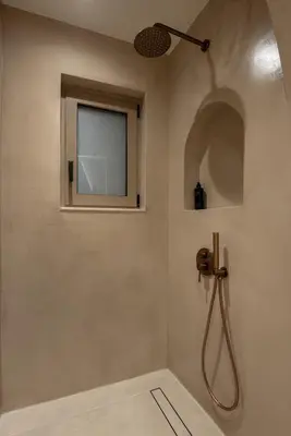 a bathroom with a shower with a window at Devina Residence 2025 , Luxury City Jacuzzi Apartment in Chania Town
