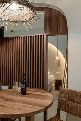 a bottle of wine sitting on a wooden table at Devina Residence 2025 , Luxury City Jacuzzi Apartment in Chania Town