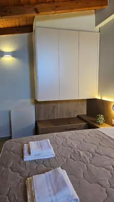 a bedroom with a bed with two towels on it at Reflections Apartments in Stalos